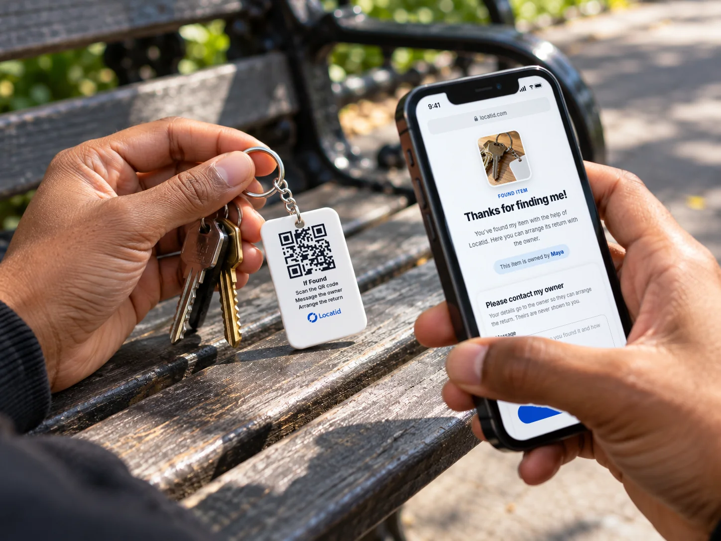 Someone holding a found set of keys with a Locatid tag, the finder page open on their phone